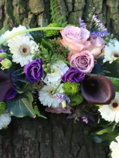 Sympathy wreath in white and purple dartford florist