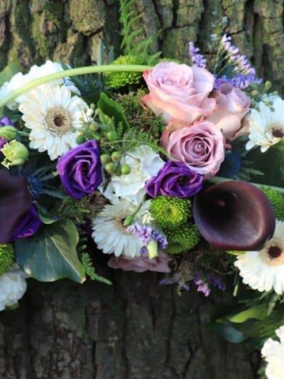 Sympathy wreath in white and purple dartford florist