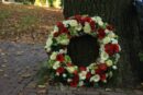 Sympathy wreath near a tree dartford florist