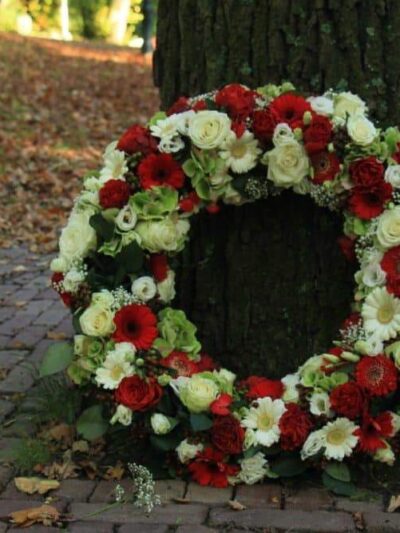 Sympathy wreath near a tree dartford florist