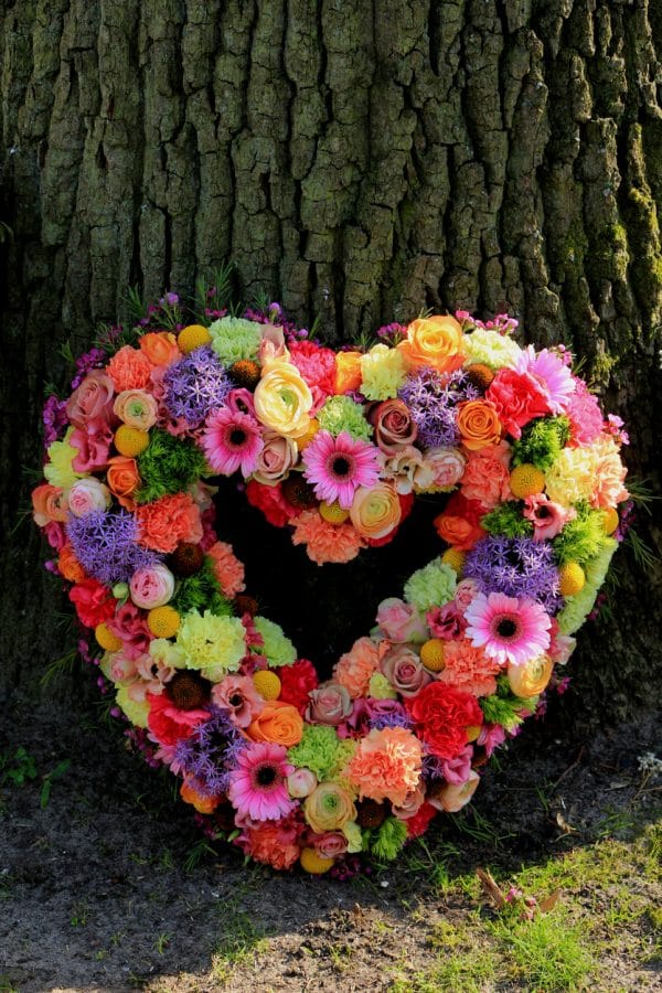 Pastel Sympathy flowers near a tree dartford florist