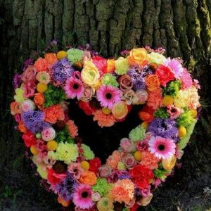 Pastel Sympathy flowers near a tree dartford florist