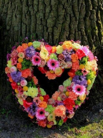 Pastel Sympathy flowers near a tree dartford florist