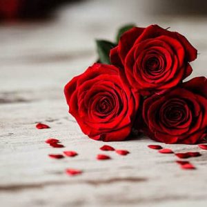 Three red roses and little red hearts dartford florist