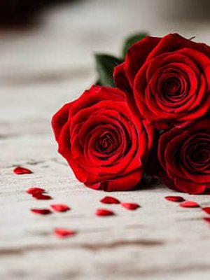 Three red roses and little red hearts dartford florist