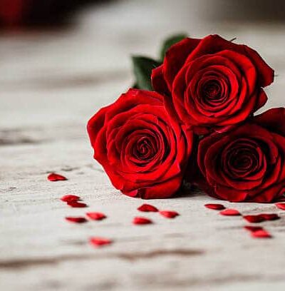 Three red roses and little red hearts dartford florist