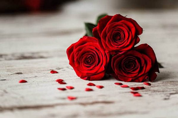 Three red roses and little red hearts dartford florist